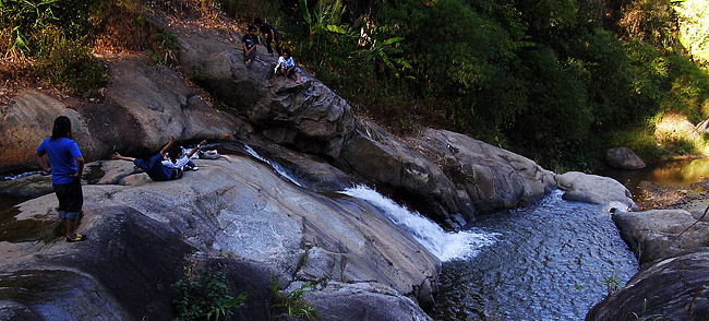 Natural waterslides at a waterfall in Pai